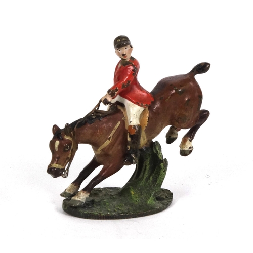 596 - Cold painted bronze model of a huntsman on horseback jumping over a fence, 5cm high