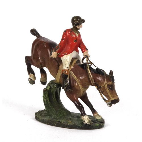 596 - Cold painted bronze model of a huntsman on horseback jumping over a fence, 5cm high