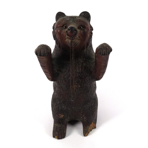 47 - Black Forest carved wooden standing bear with beaded glass eyes, 30cm high