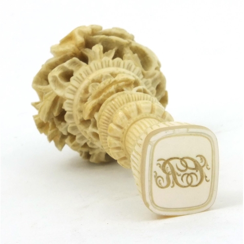 619 - Oriental Chinese ivory and mother of pearl seal with carved floral decoration, 7cm long