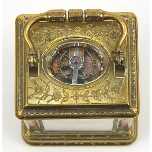 1306 - Miniature brass carriage clock, with floral and enamel dial, the movement stamped 01885, 7cm high ex... 