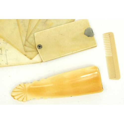 29 - Ivory aide de memoire, ivory shoe horn and a child's comb, the largest 12cm long