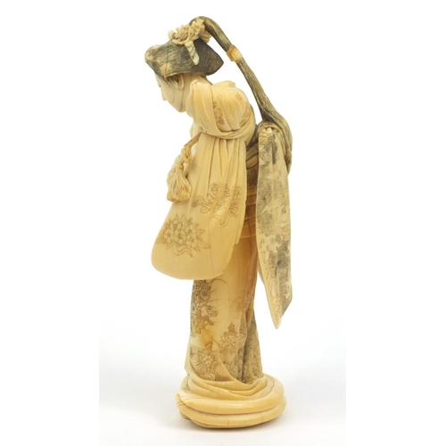 607 - Oriental Japanese ivory carving of a lady with floral gown, signature mark to base, 19cm high