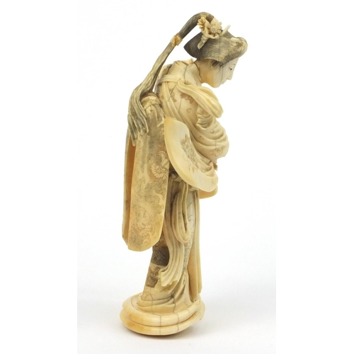 607 - Oriental Japanese ivory carving of a lady with floral gown, signature mark to base, 19cm high