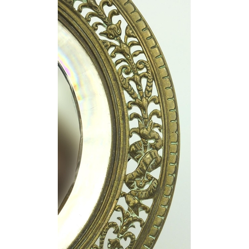 37 - Victorian pierced brass cherub easel framed mirror, 25cm diameter