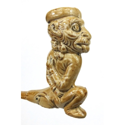 113 - Antique salt glazed stoneware pipe modelled as a monkey, 12cm diameter