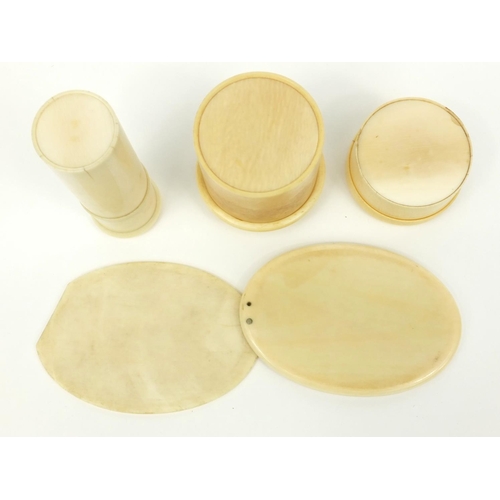 30 - Three ivory screw top containers, together with an ivory hand mirror, the hand mirror 11cm long when... 