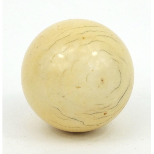 26 - Three ivory snooker balls, the largest 4.5cm diameter