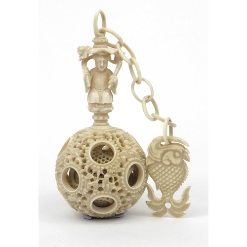 616 - Oriental Chinese puzzle ball on chain carved with figures and fish, 25cm long