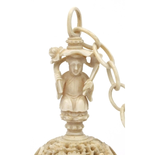 616 - Oriental Chinese puzzle ball on chain carved with figures and fish, 25cm long