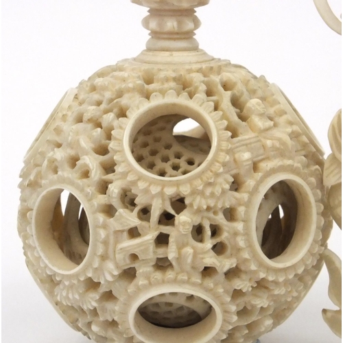 616 - Oriental Chinese puzzle ball on chain carved with figures and fish, 25cm long