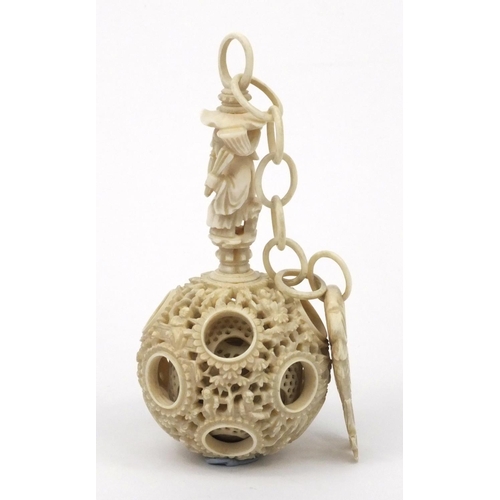 616 - Oriental Chinese puzzle ball on chain carved with figures and fish, 25cm long