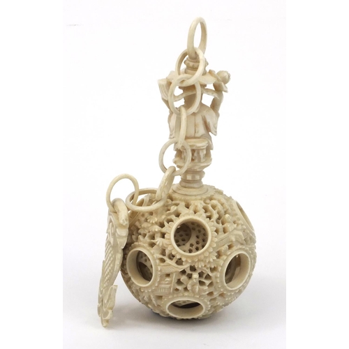 616 - Oriental Chinese puzzle ball on chain carved with figures and fish, 25cm long