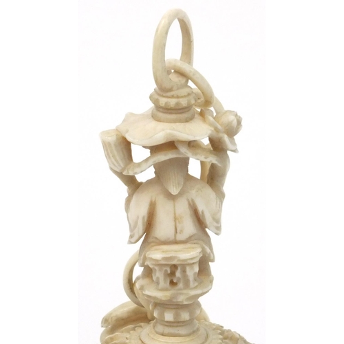 616 - Oriental Chinese puzzle ball on chain carved with figures and fish, 25cm long