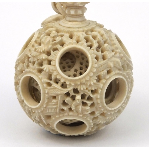 616 - Oriental Chinese puzzle ball on chain carved with figures and fish, 25cm long