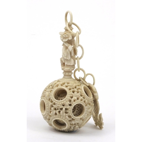 616 - Oriental Chinese puzzle ball on chain carved with figures and fish, 25cm long