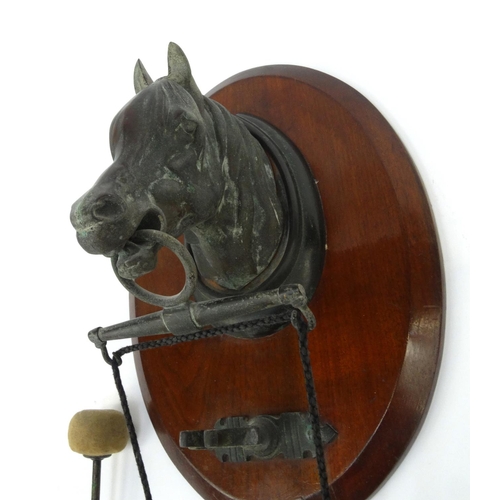 36 - Wooden bronzed horse's head dinner gong, 26cm diameter