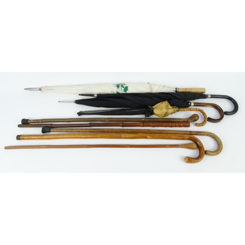 423 - Small selection of assorted walking sticks and umbrellas