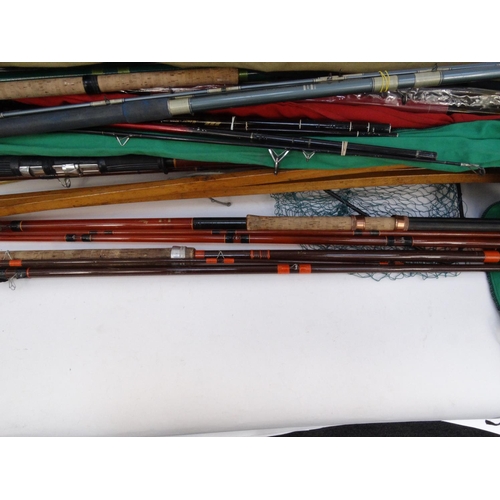 532 - Large selection of mostly sea-fishing rods, together with some landing nets