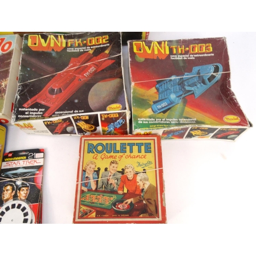 522 - Box of vintage toys including Merit electric derby, two Madel spaceships, Escalado, etc