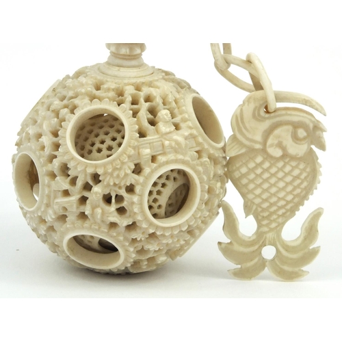 616 - Oriental Chinese puzzle ball on chain carved with figures and fish, 25cm long