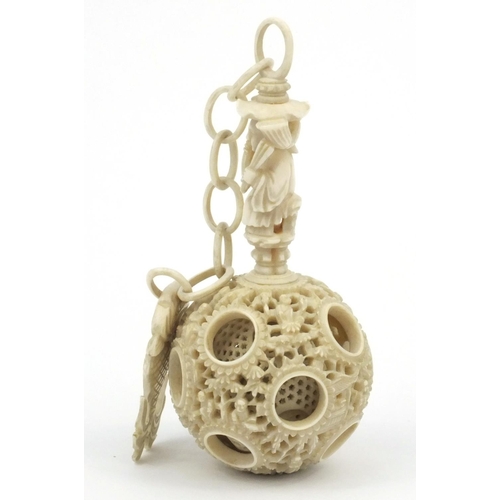 616 - Oriental Chinese puzzle ball on chain carved with figures and fish, 25cm long