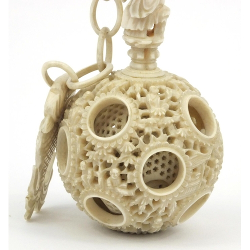 616 - Oriental Chinese puzzle ball on chain carved with figures and fish, 25cm long