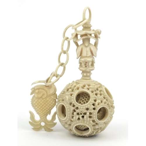 616 - Oriental Chinese puzzle ball on chain carved with figures and fish, 25cm long