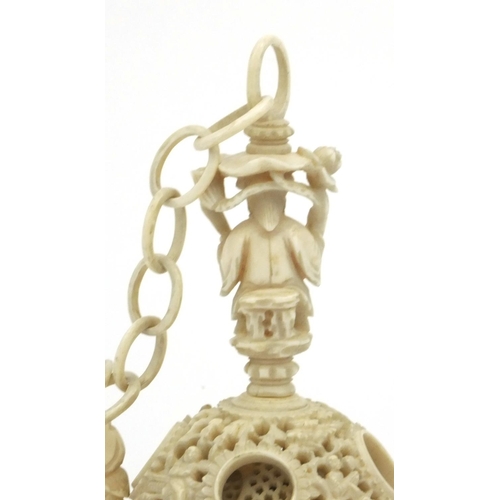 616 - Oriental Chinese puzzle ball on chain carved with figures and fish, 25cm long