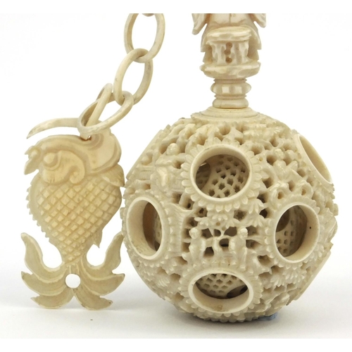 616 - Oriental Chinese puzzle ball on chain carved with figures and fish, 25cm long