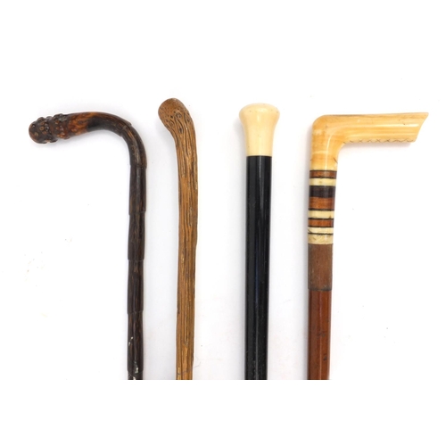 63 - Two ivory topped walking sticks, cane and a lady's silk parasol