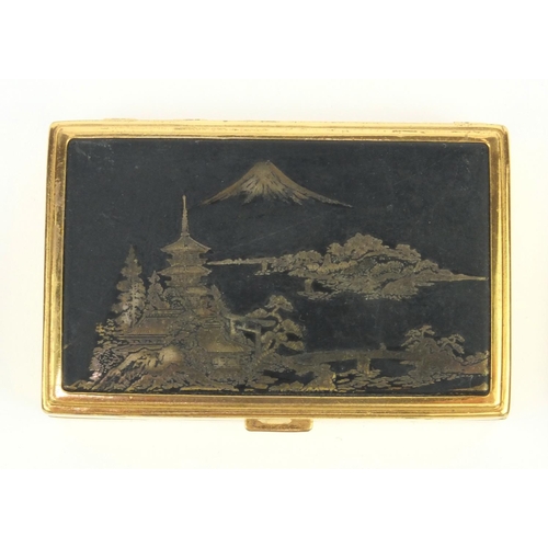 205 - Japanese musical compact, circular Japanese compact and a silver metal compact, the largest 7.5cm di... 