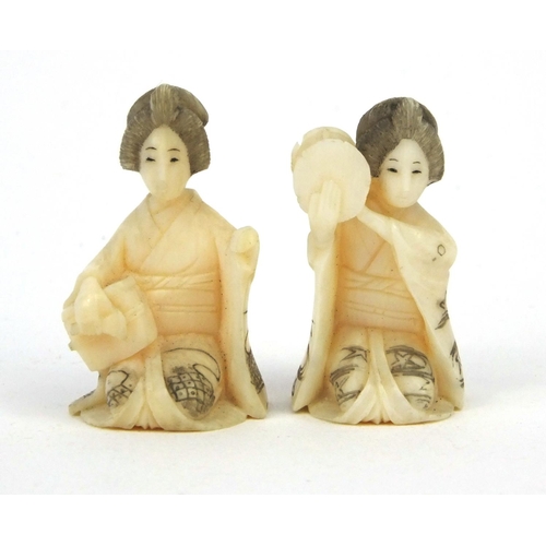 610 - Two miniature oriental Japanese carved ivory figures of geisha girls, both 3cm high