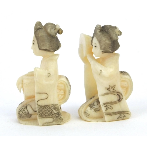 610 - Two miniature oriental Japanese carved ivory figures of geisha girls, both 3cm high