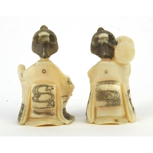 610 - Two miniature oriental Japanese carved ivory figures of geisha girls, both 3cm high