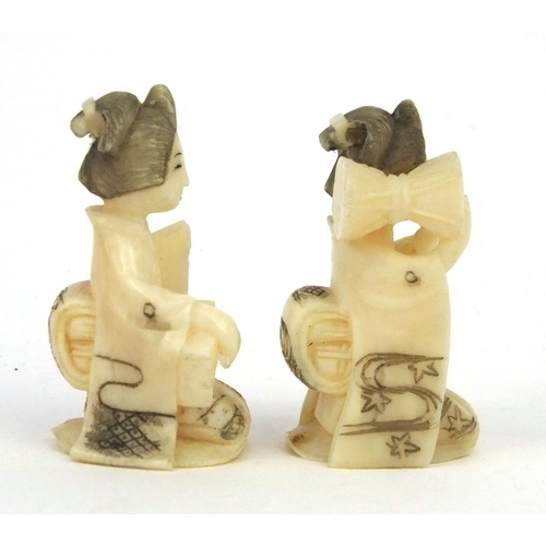 610 - Two miniature oriental Japanese carved ivory figures of geisha girls, both 3cm high