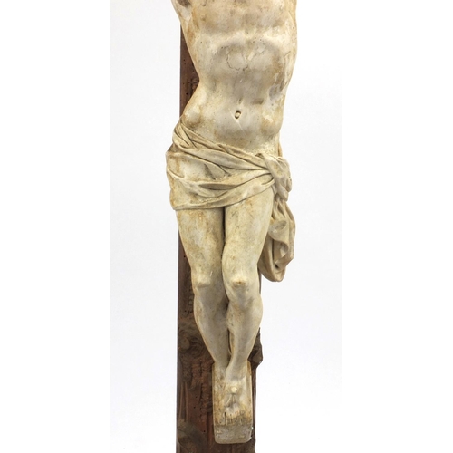 44 - Plaster Corpus Christi mounted on a wooden crucifix, 85cm high including the base