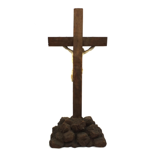 44 - Plaster Corpus Christi mounted on a wooden crucifix, 85cm high including the base