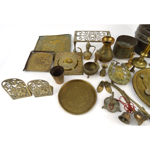 457 - Assorted copper and brass items including trays, trivet, horse brasses, Middle Eastern items, etc