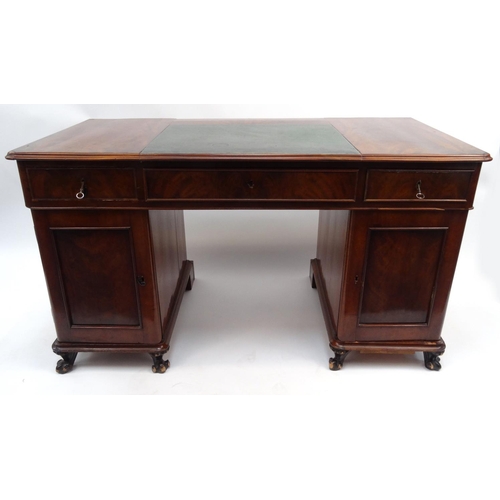 26 - Mahogany twin pedestal desk fitted with three drawers above two doors enclosing shelves, 79cm high x... 