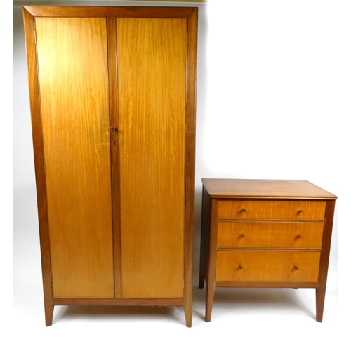 30 - Teak two door wardrobe and a three drawer chest with label 'Designer Made by Storys, Kensington, Lon... 