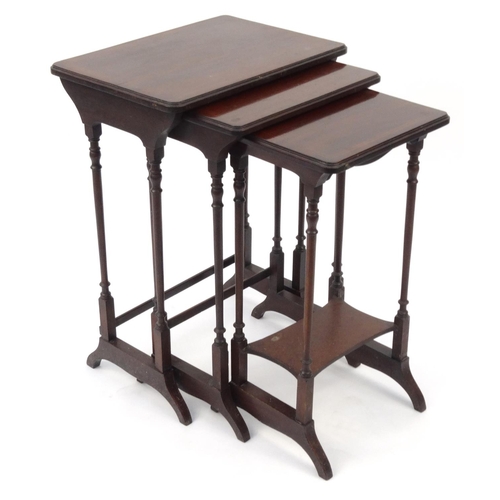 34 - Nest of three inlaid mahogany occasional tables, the larger 62cm high