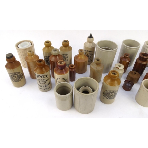 516 - Large selection of assorted stoneware advertising bottles