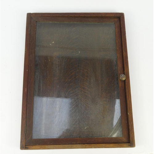 448 - Oak wall hanging noticeboard with hinged glass door, 69cm high x 52cm wide x 5cm deep