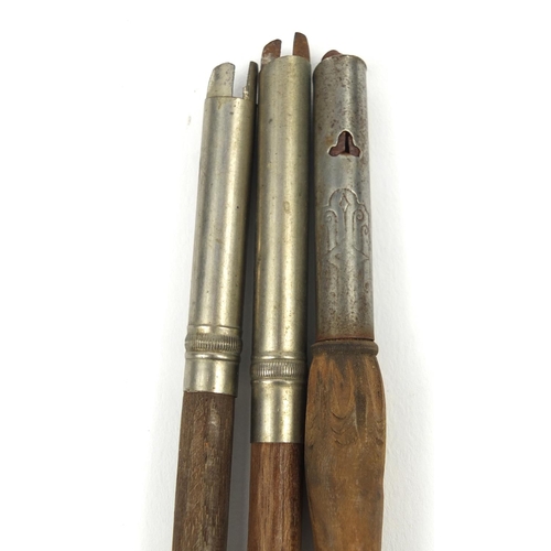 104 - Three carved wooden Black Forest dip pens - one with a bear, the largest 22cm long