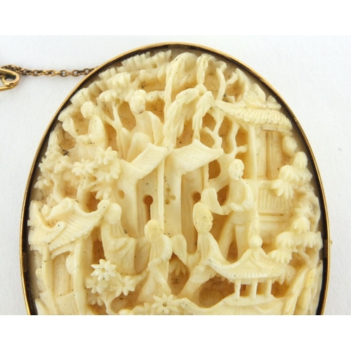 621 - Oriental Chinese carved ivory panel of pagodas and figures with 9ct gold brooch mount