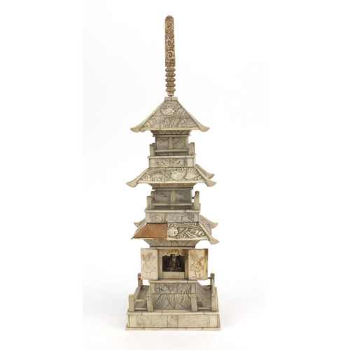 605 - Oriental Chinese ivory pagoda with doors revealing a miniature Buddha decorated with birds and figur... 