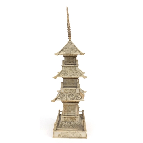 605 - Oriental Chinese ivory pagoda with doors revealing a miniature Buddha decorated with birds and figur... 