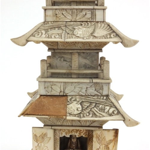 605 - Oriental Chinese ivory pagoda with doors revealing a miniature Buddha decorated with birds and figur... 