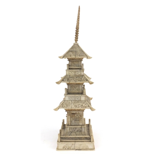 605 - Oriental Chinese ivory pagoda with doors revealing a miniature Buddha decorated with birds and figur... 